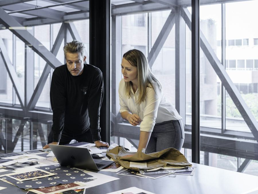 Two people reviewing a document together at a desk