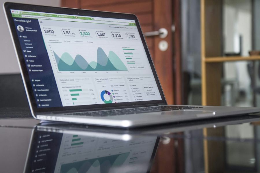 Laptop on a desk showing a daily numbers report